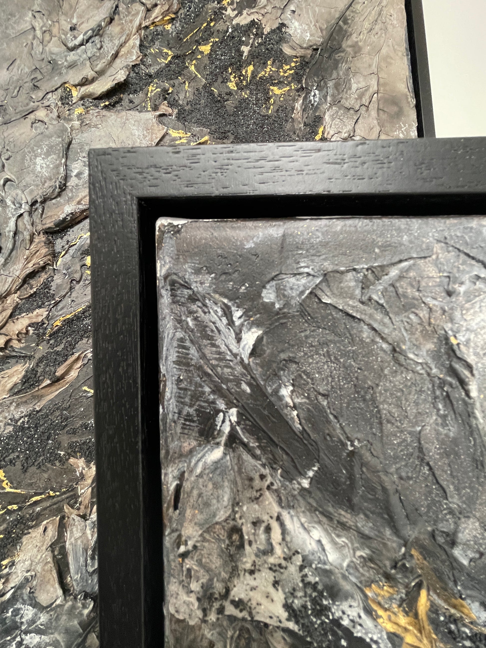 Omen | Original textured abstract artwork on canvas with dark neutral palette, gold-leaf and sand |7070cm | ready to hang in black Obeche wood frame. Chris Moss Art