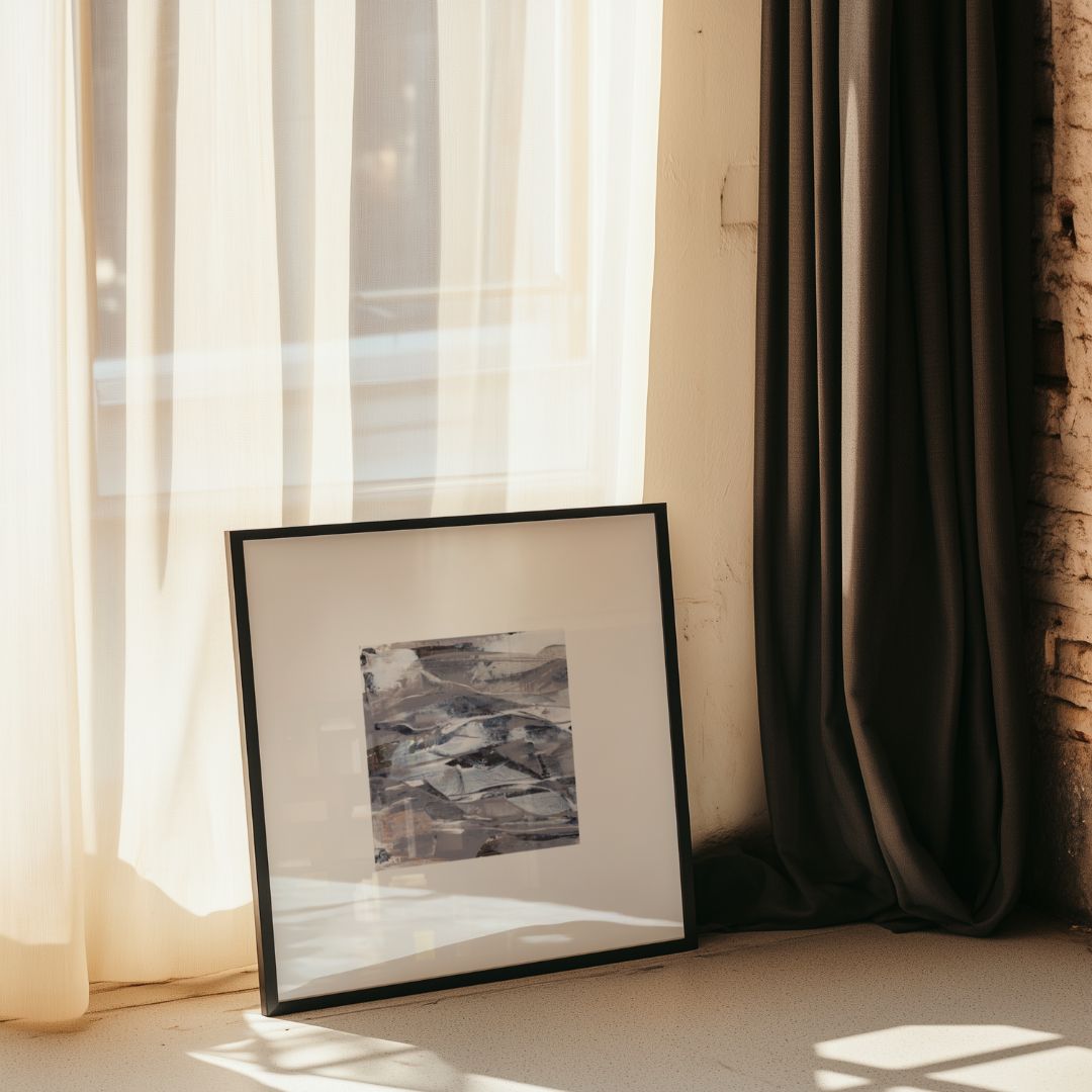Fathom | neutral gold taupe black and white abstract fine art print | styled against a bright window and curtain in a black frame | Chris Moss Art